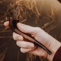 pipe in hand, smoking outside
